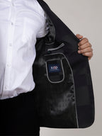 Black blazer with a visible brand logo over a white shirt on a neutral background