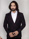 Man wearing a dark suit and white shirt against a plain background