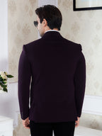 Man wearing a dark purple suit jacket in an indoor setting