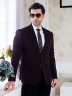 Man wearing a dark suit with sunglasses indoors