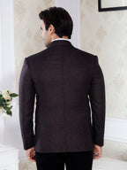 Man wearing a dark Brown suit jacket in an indoor setting
