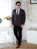Man in a dark suit standing in a room with decorative elements
