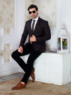 Man in a black suit with sunglasses sitting on a white bench.