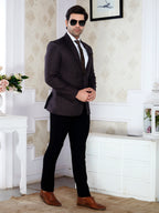 Man in a suit standing in a room with decorative elements